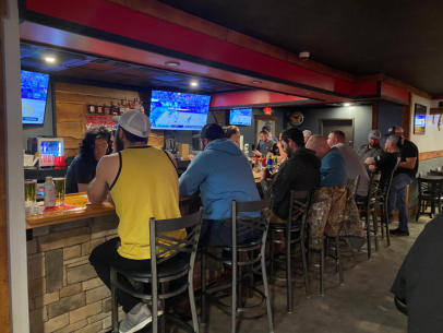 People siting at the bar at Trailhead Bar and Grill