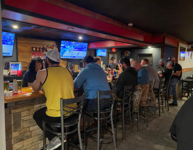 People siting at the bar at Trailhead Bar and Grill