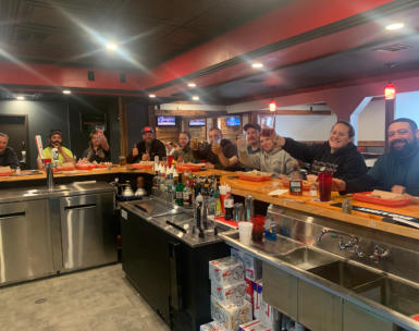 People siting at the bar at Trailhead Bar and Grill taken from the owner side of the bar